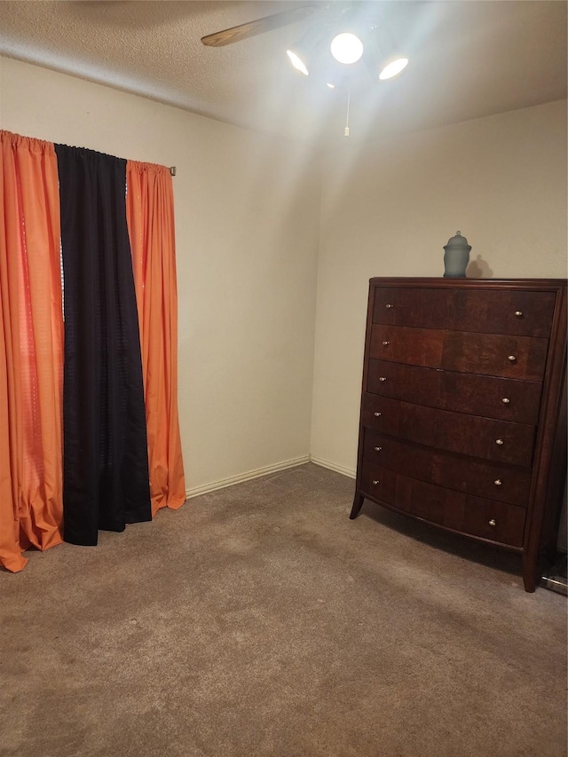 unfurnished bedroom with ceiling fan and carpet