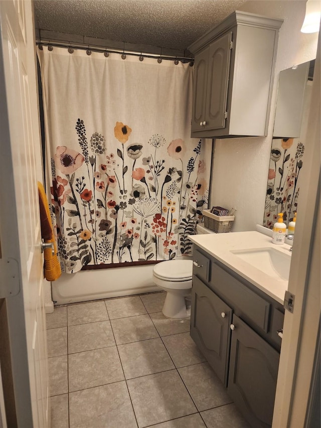 full bathroom featuring toilet, vanity, shower / bath combo, tile patterned floors, and a textured ceiling