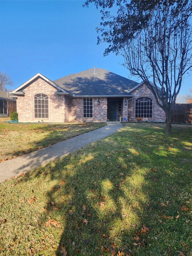 ranch-style home featuring a front yard