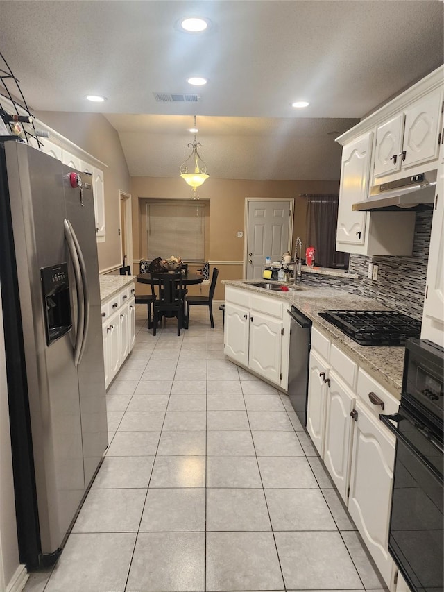 kitchen featuring decorative light fixtures, white cabinetry, and black appliances