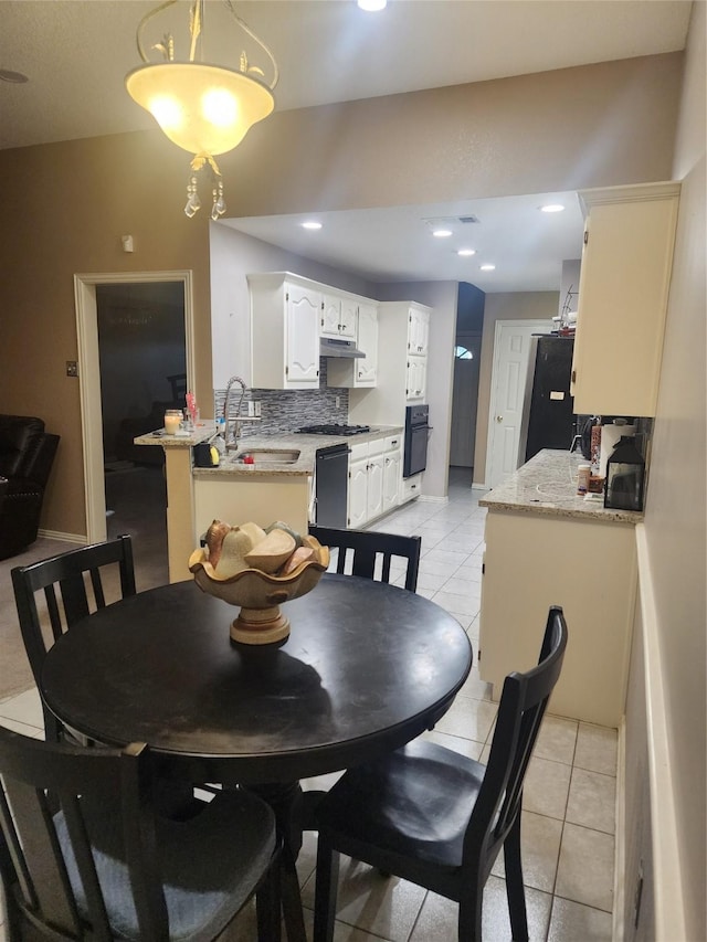 dining space featuring light tile patterned flooring and sink