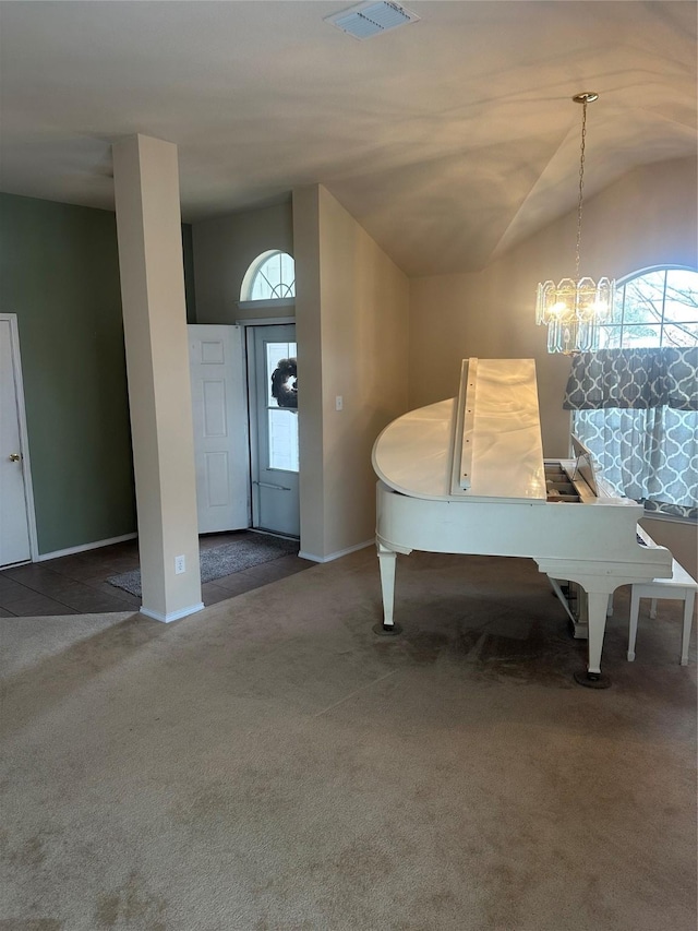 unfurnished dining area featuring vaulted ceiling, an inviting chandelier, and dark carpet