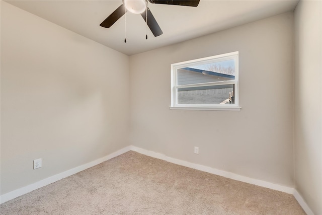 empty room featuring ceiling fan and light carpet