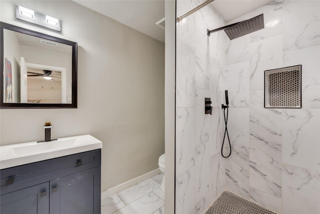 bathroom featuring toilet, vanity, and tiled shower