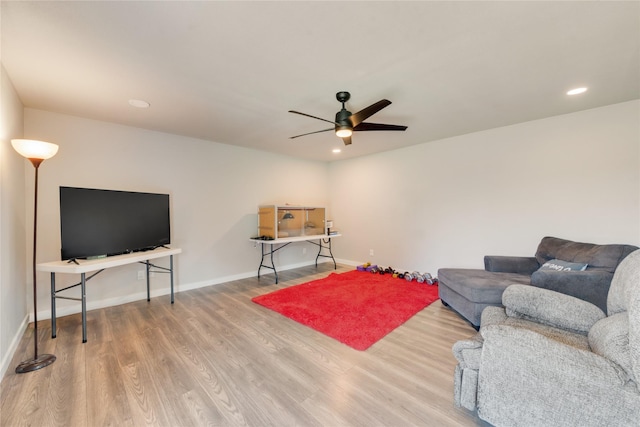 sitting room with hardwood / wood-style flooring and ceiling fan