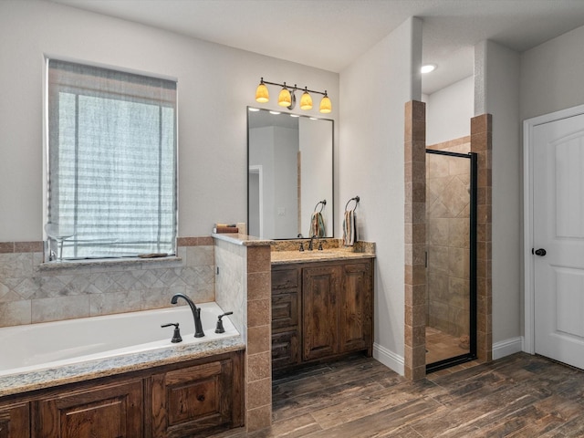 bathroom with vanity and independent shower and bath