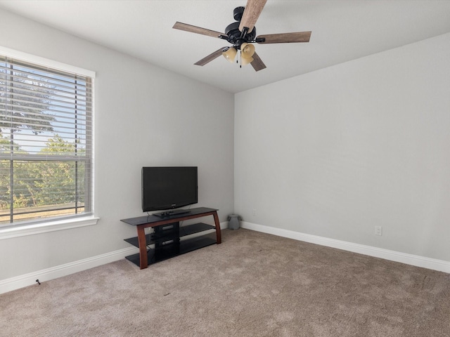 carpeted living room featuring ceiling fan and a healthy amount of sunlight