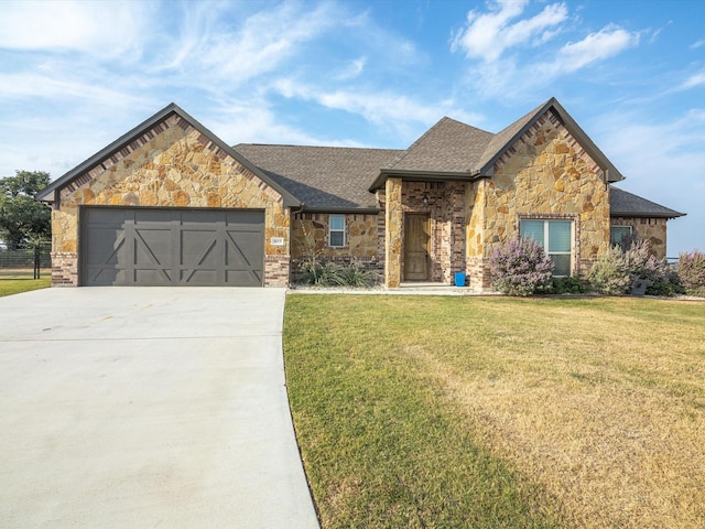 view of front of home featuring a garage and a front yard