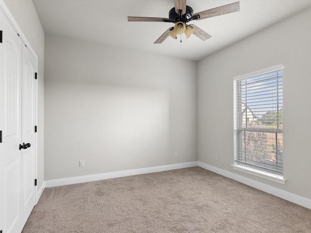 carpeted empty room with ceiling fan