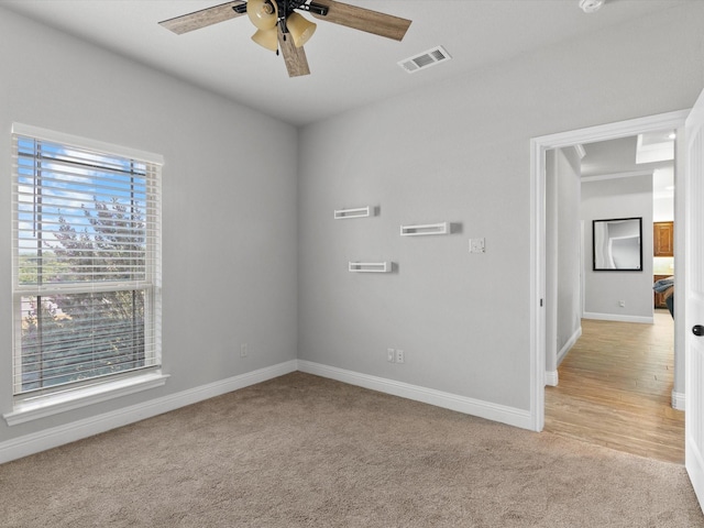 empty room with light carpet and ceiling fan