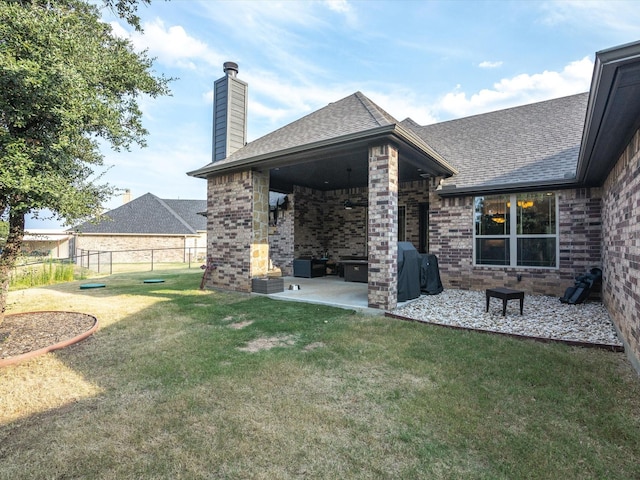 view of yard featuring ceiling fan and a patio