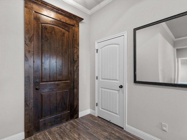 foyer featuring dark wood-type flooring and ornamental molding