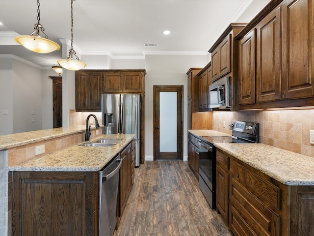 kitchen featuring appliances with stainless steel finishes, pendant lighting, ornamental molding, and backsplash