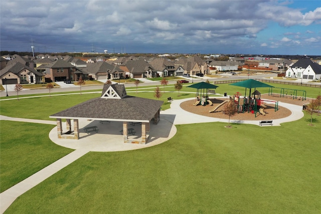 surrounding community featuring playground community, a yard, and a residential view