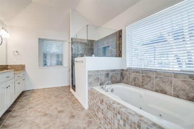 bathroom featuring vaulted ceiling, shower with separate bathtub, plenty of natural light, and vanity