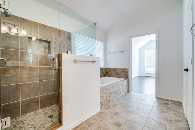 bathroom featuring plus walk in shower, lofted ceiling, and tile patterned flooring