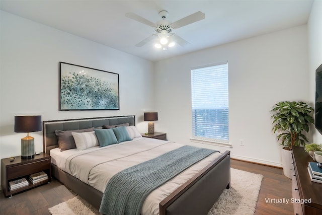 bedroom with ceiling fan and dark hardwood / wood-style floors