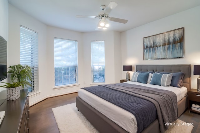 bedroom with ceiling fan and dark hardwood / wood-style flooring