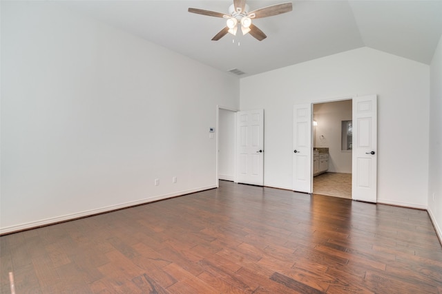 unfurnished bedroom featuring ceiling fan, dark hardwood / wood-style floors, ensuite bathroom, and lofted ceiling