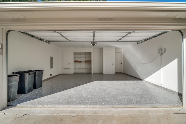 garage with a garage door opener and electric panel