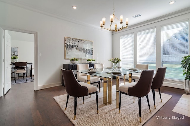 dining space with dark hardwood / wood-style flooring, ornamental molding, and an inviting chandelier