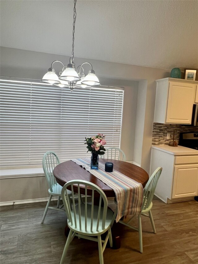 kitchen featuring a center island, vaulted ceiling, sink, backsplash, and stainless steel appliances