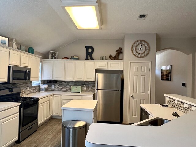 laundry area featuring dark wood-type flooring, a textured ceiling, and washing machine and dryer