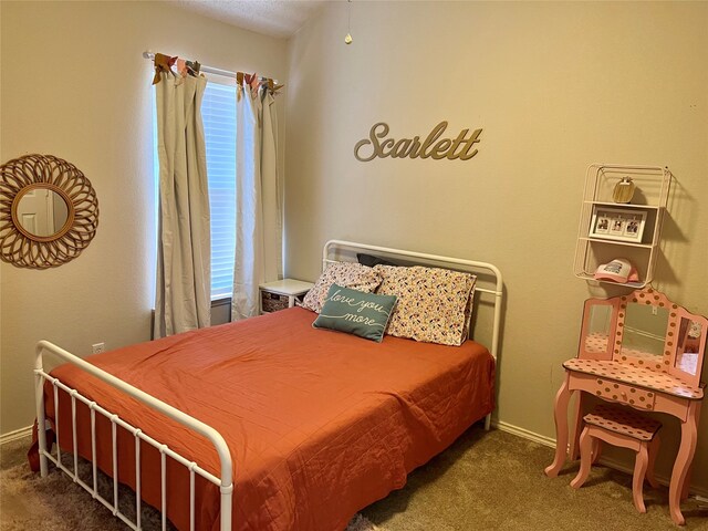 bedroom featuring light carpet, ceiling fan, and a crib