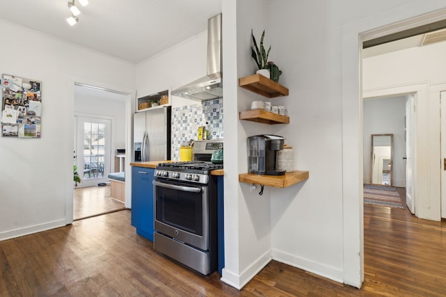 kitchen with butcher block counters, stainless steel appliances, backsplash, dark hardwood / wood-style flooring, and wall chimney range hood