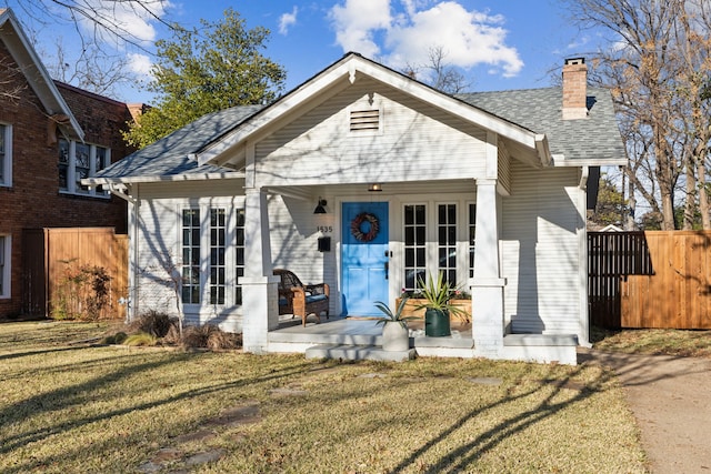 view of front of home featuring a front yard and french doors