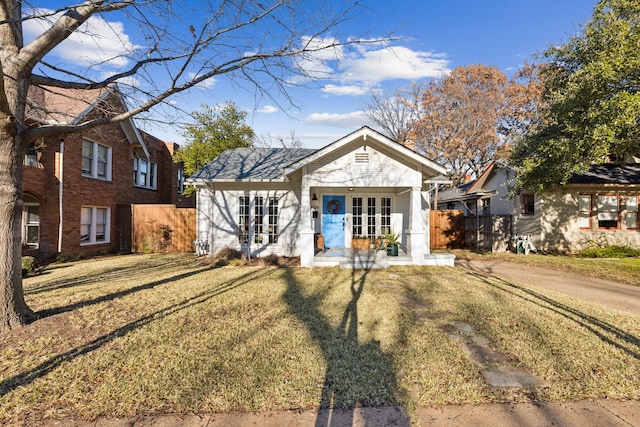 view of front of house featuring a front yard and french doors