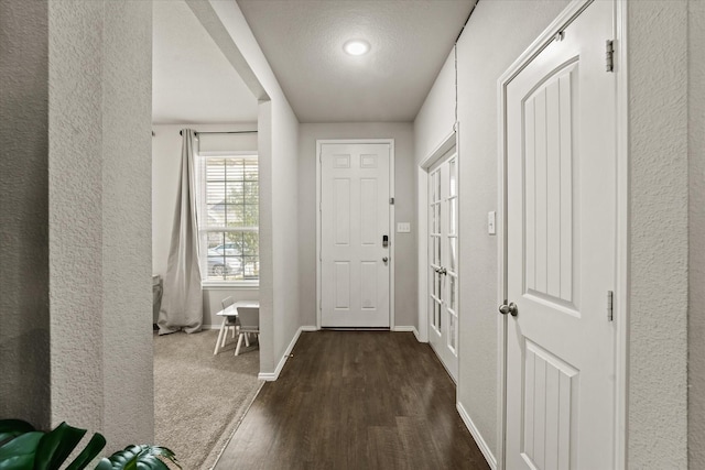 entryway featuring a textured ceiling and dark hardwood / wood-style floors