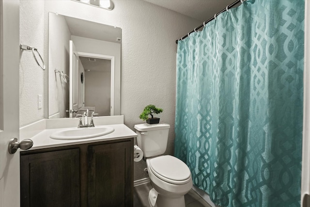 bathroom with toilet, vanity, and curtained shower