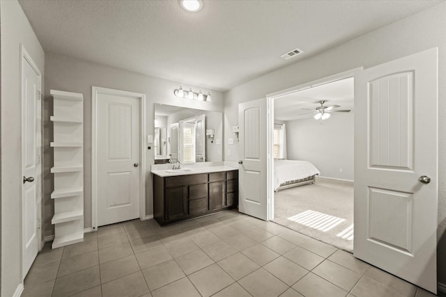 bathroom with ceiling fan, a wealth of natural light, vanity, and tile patterned flooring