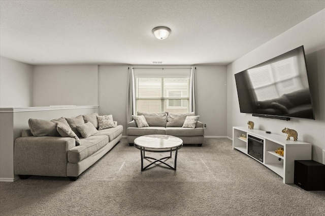 carpeted living room featuring a textured ceiling