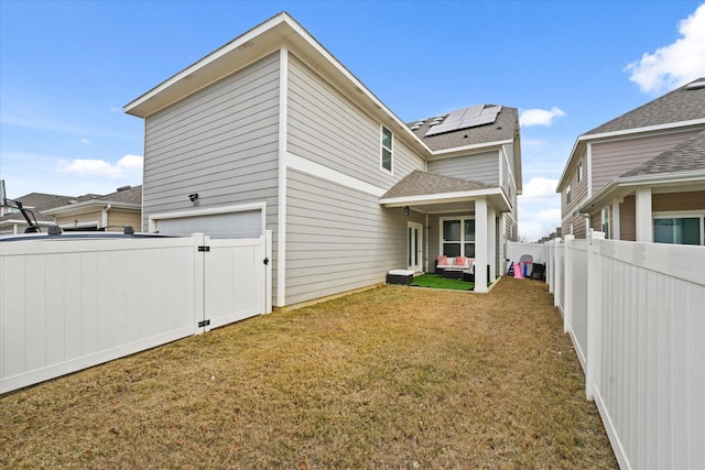 exterior space featuring a yard and solar panels