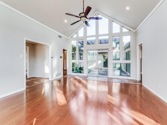 unfurnished living room featuring high vaulted ceiling, ceiling fan, and plenty of natural light