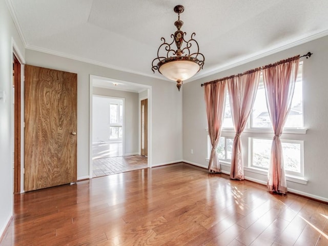 unfurnished room with a wealth of natural light, crown molding, and hardwood / wood-style floors