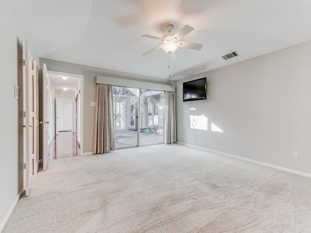 carpeted spare room with ceiling fan