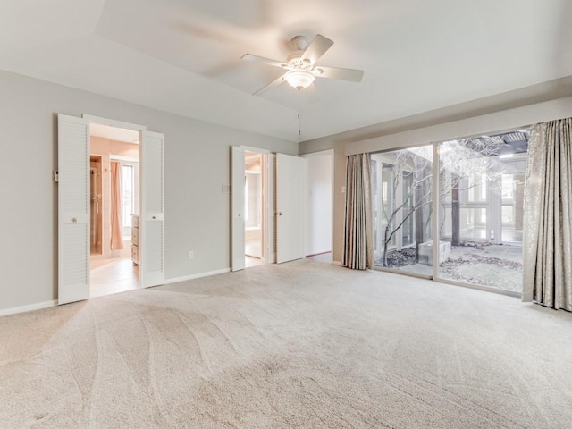 spare room featuring ceiling fan, a wealth of natural light, and carpet floors