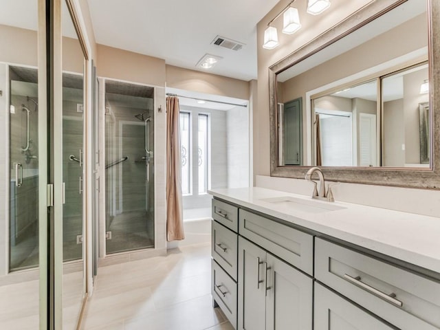 bathroom featuring a shower with shower door and vanity