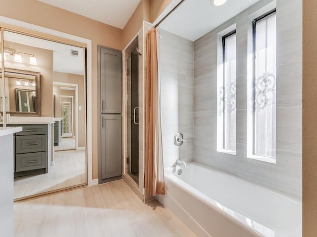 bathroom featuring shower / tub combo and vanity