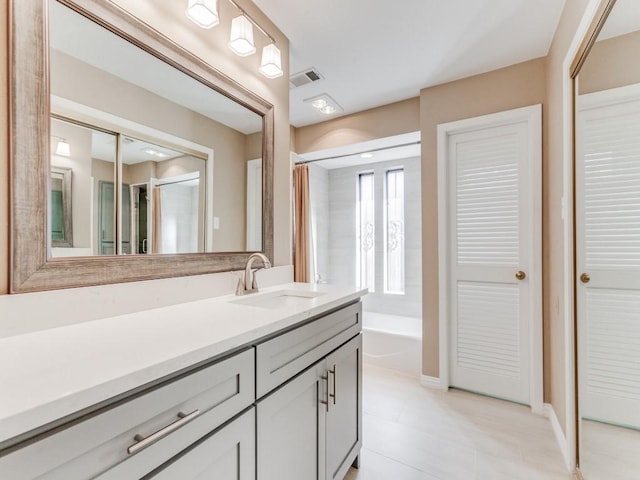 bathroom with a washtub and vanity