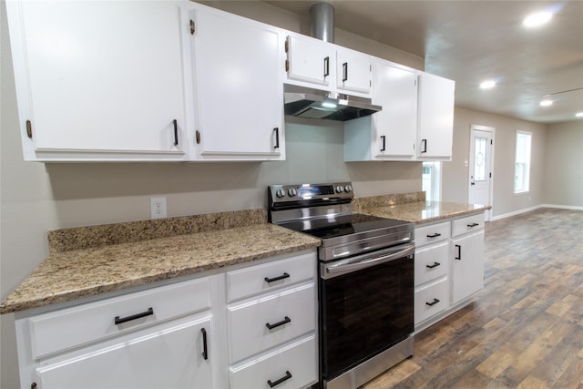 kitchen featuring dark wood-type flooring, light stone countertops, white cabinetry, and stainless steel range with electric cooktop