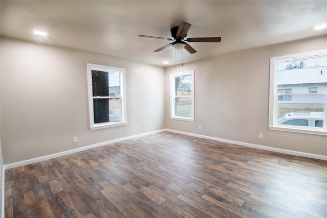 unfurnished room with ceiling fan and dark wood-type flooring