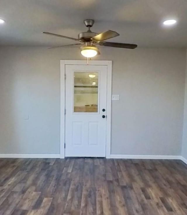 interior space with ceiling fan and dark wood-type flooring