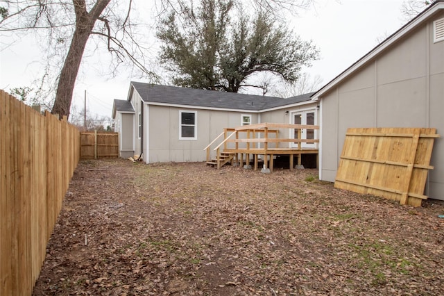 back of house with a wooden deck