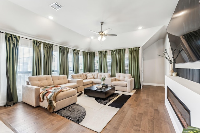 living room featuring lofted ceiling, ceiling fan, and hardwood / wood-style flooring