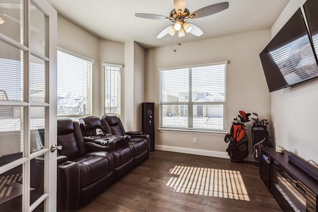 living room featuring ceiling fan and dark hardwood / wood-style floors