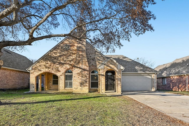 view of front of house with a garage and a front lawn